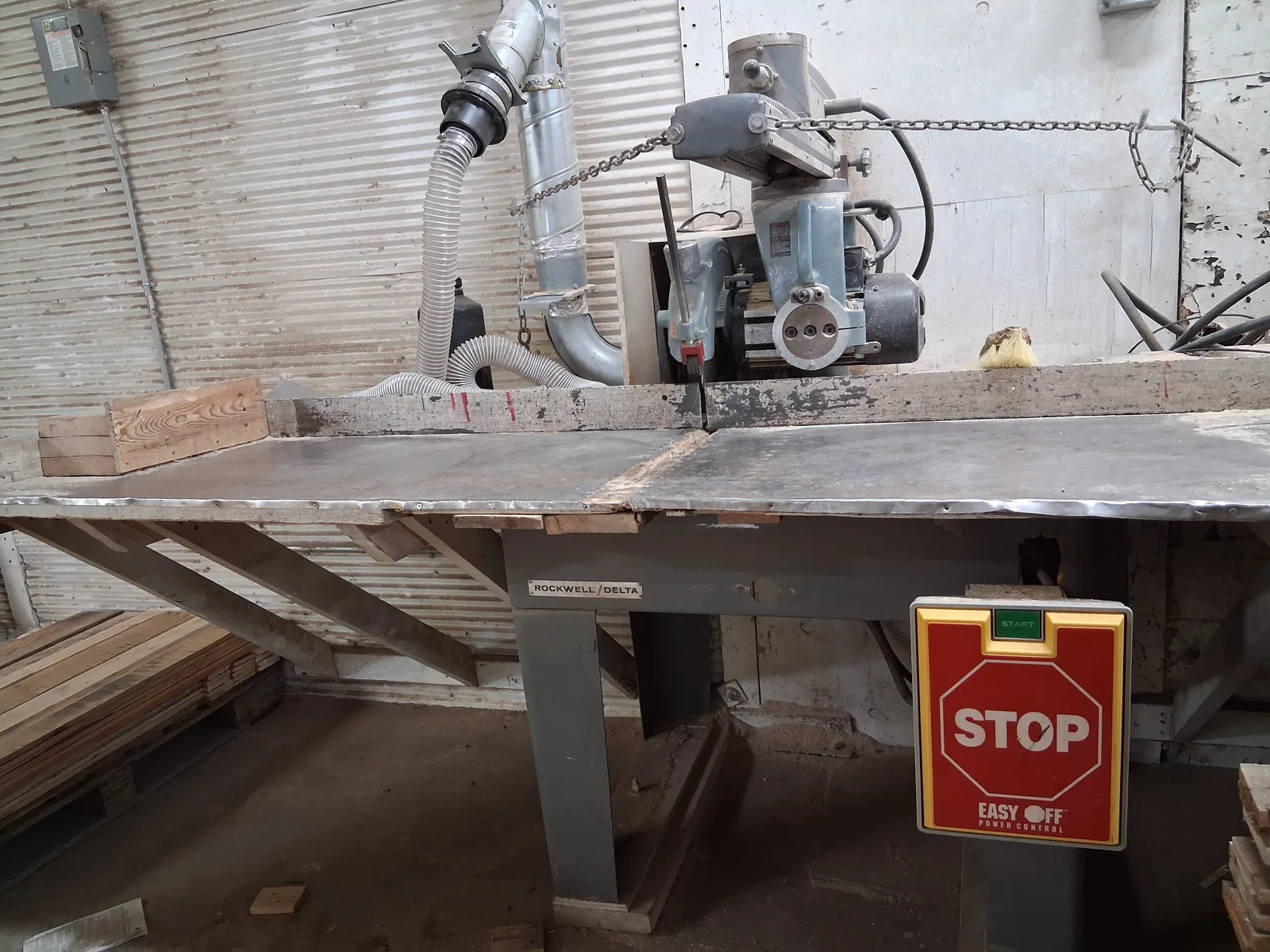 Radial arm saw with E-stop sign