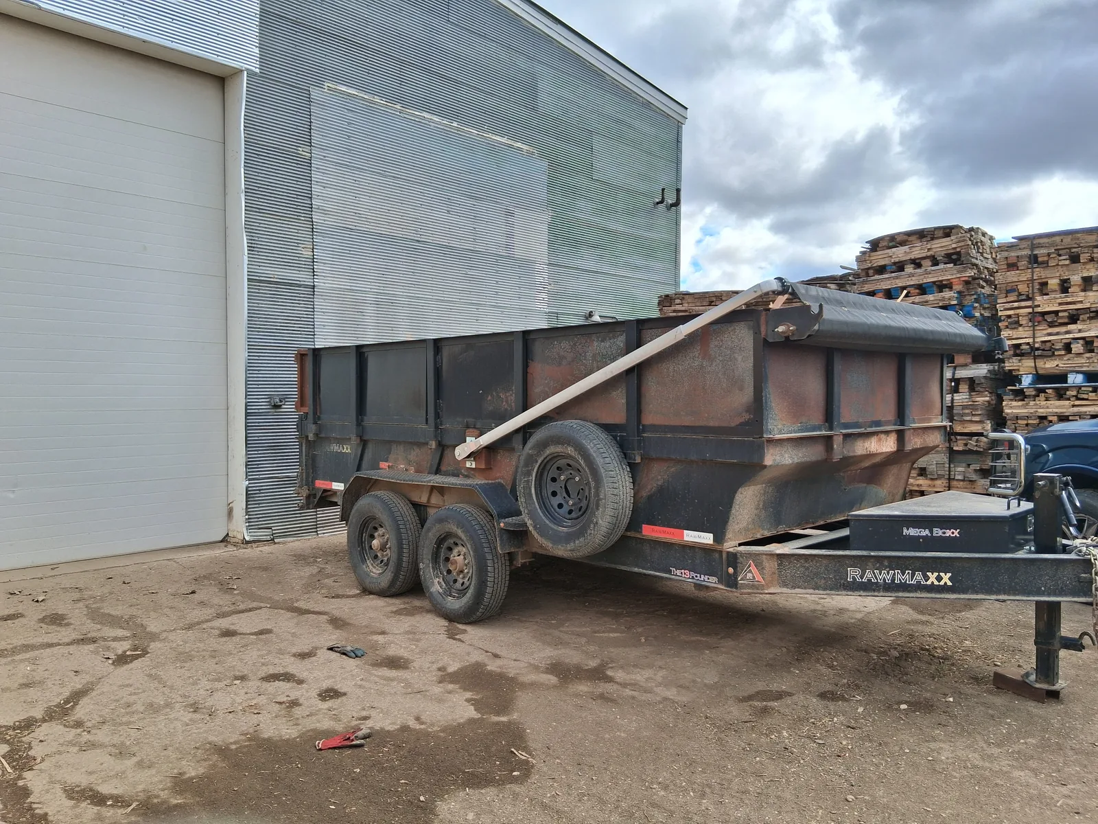 Black trailer used for wood dust, small scrap, and unusable wood recycling